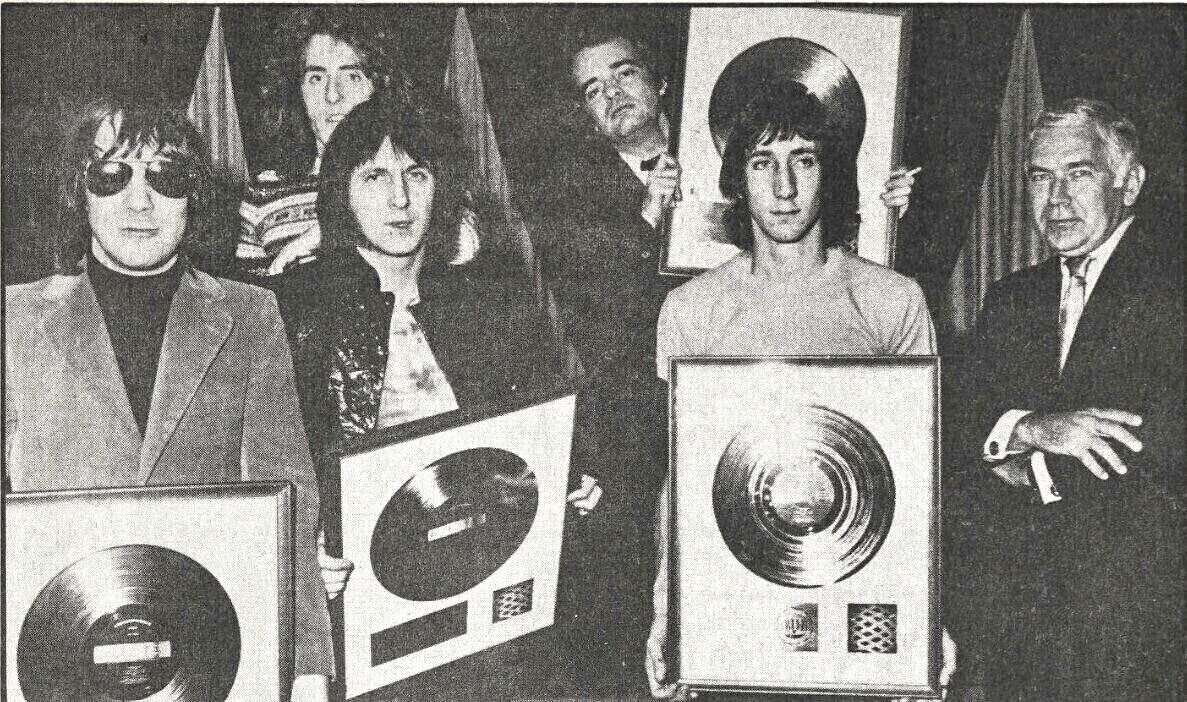 The Who and manager Kit Lambert posing with a gold record for Tommy in 1969