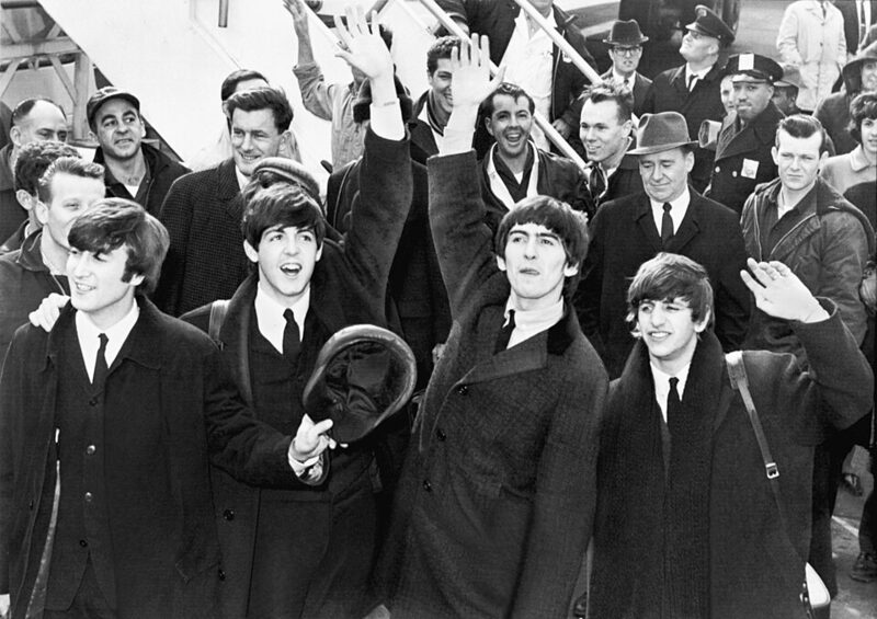The Beatles waving to fans after landing at JFK Airport, February 1964