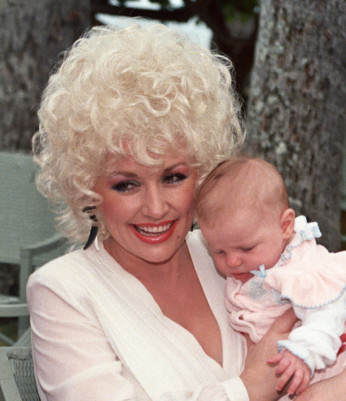 Dolly Parton performing in 2013, the country icon who died August 25, 2026 at age 80